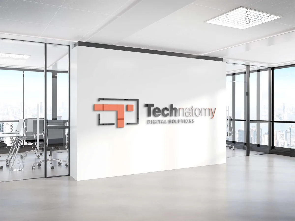 Technatomy Digital Solutions logo presented as dimensional signage on an office wall